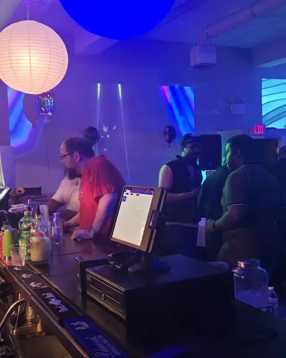 Staff serving at the upstairs bar in Midtown Hall during an event.